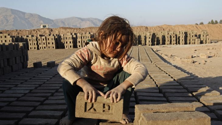 Afghan girl works at a brick-making factory in Nangarhar
