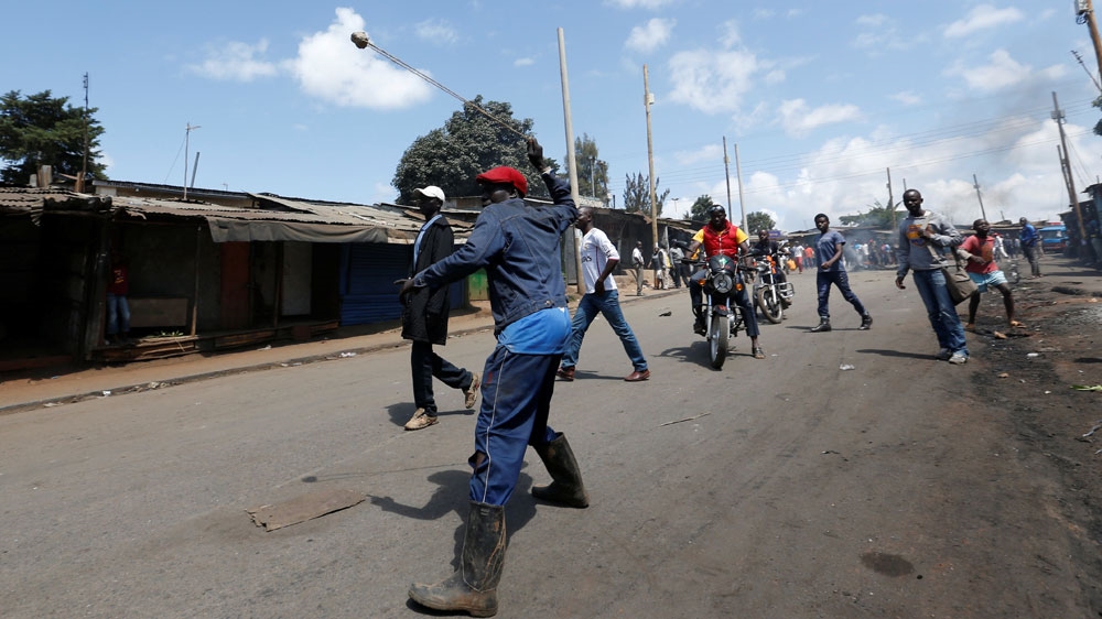 An opposition supporter uses a sling to hurl stones towards their opponents during a protest in Nairobi [Reuters]