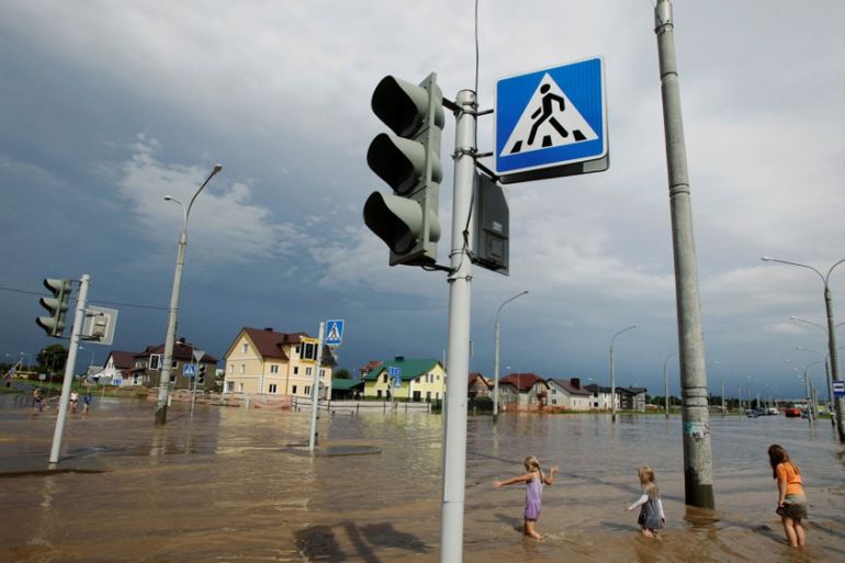 Children enjoying the impromptu paddling pool, after a thunderstorm, on a flooded street in Minsk, Belarus