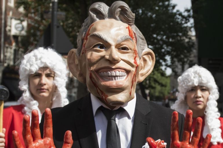 Protesters dressed as Tony Blair hold a demonstration outside the Queen Elizabeth II Conference Centre as they wait for the release of the Chilcot Inquiry in London, Britain [EPA]
