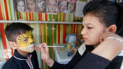 An Afghan boy has his face painted during the first day of the Muslim holiday of Eid al-Fitr in Kabul, Afghanistan [Reuters]