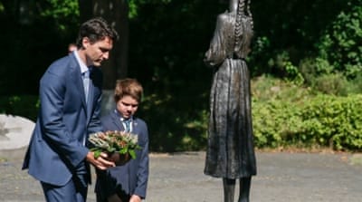 Justin Trudeau and his son Xavier lay flowers at a monument to the victims of the Great Famine in Kiev, Ukraine [EPA]