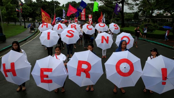 Protesters display umbrellas spelling out "Marcos is no Hero" as they join hundreds of protesters denouncing the planned burial of late dictator Ferdinand Marcos at the Libingan ng mga Bayani (Heroe''s