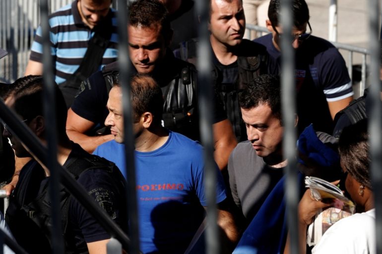 Turkish soldiers, who fled to Greece in a helicopter and requested political asylum after a failed military coup against the government, are escorted by special police forces in Athens