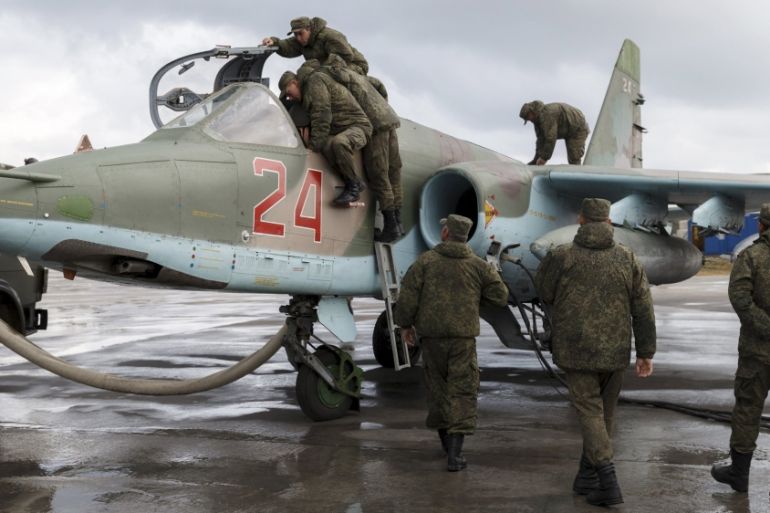 Support personnel prepare Russian Su-25 at Hmeymim airbase