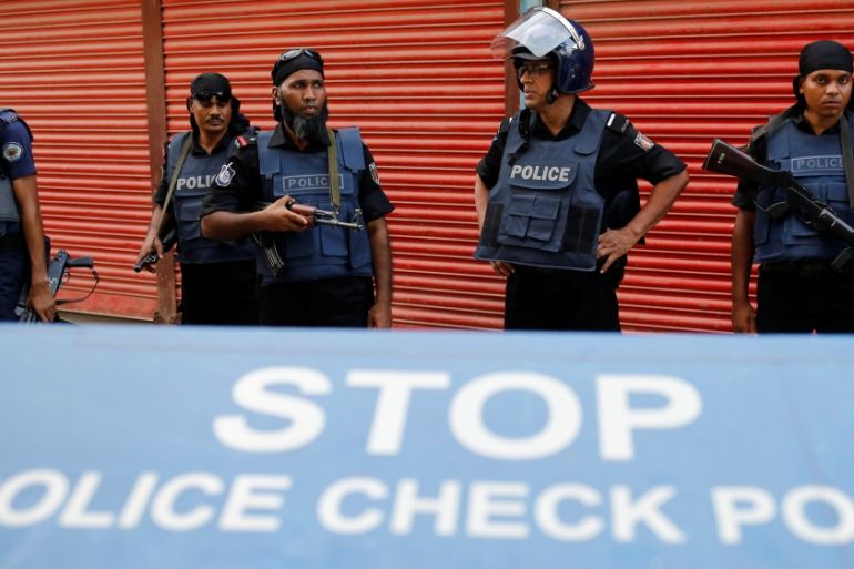 Police keep watch near the site of a gunbattle with militants on the outskirts of Dhaka