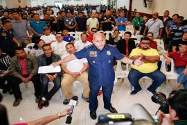 Local officials and police officers allegedly involved in the illegal drug trade surrender