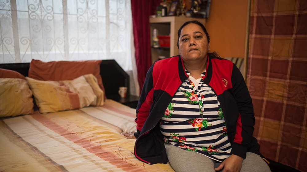Nooran Dreyer in her bedroom on Alfred Street. Facing eviction in November, Dreyer says she has 'almost given up hope' of remaining in her home of 11 years [Shaun Swingler/Al Jazeera]