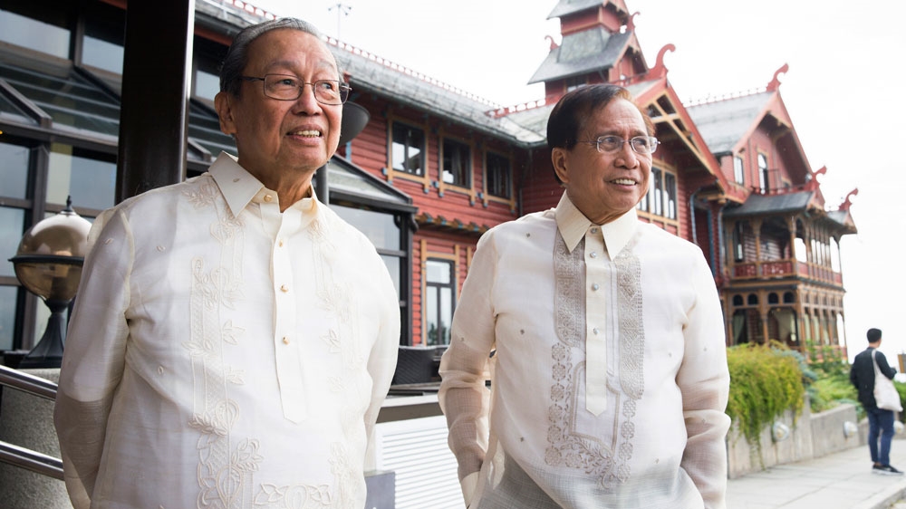 Jose Maria Sison, founder of the Communist Party of the Philippines, left, with government representative Jesus Dureza in Oslo on Monday [EPA]