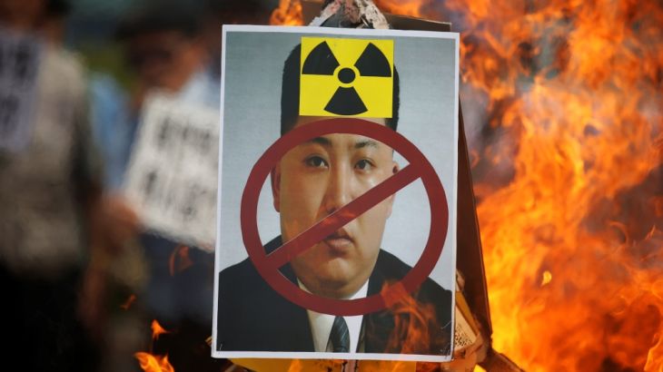 A cut-out of North Korean leader Kim Jong Un is set on fire during an anti-North Korea rally in central Seoul