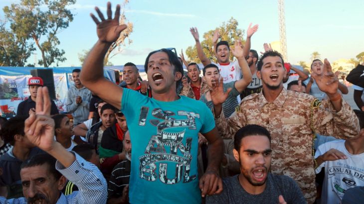 People take part in a demonstration in support General Khalifa Haftar in Benghazi