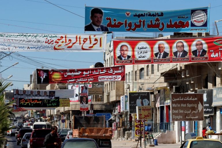 Electoral posters for parliamentary candidates are seen ahead of the general elections on Tuesday, in Madaba city, near Amman