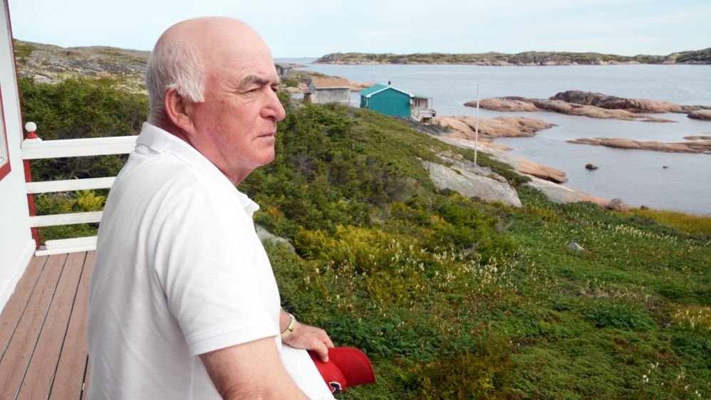 Retired lobster fisherman, Leo McKinnon, looking out from his fishing cottage in the Kecarpoui Archipelago [John Zada/Al Jazeera]