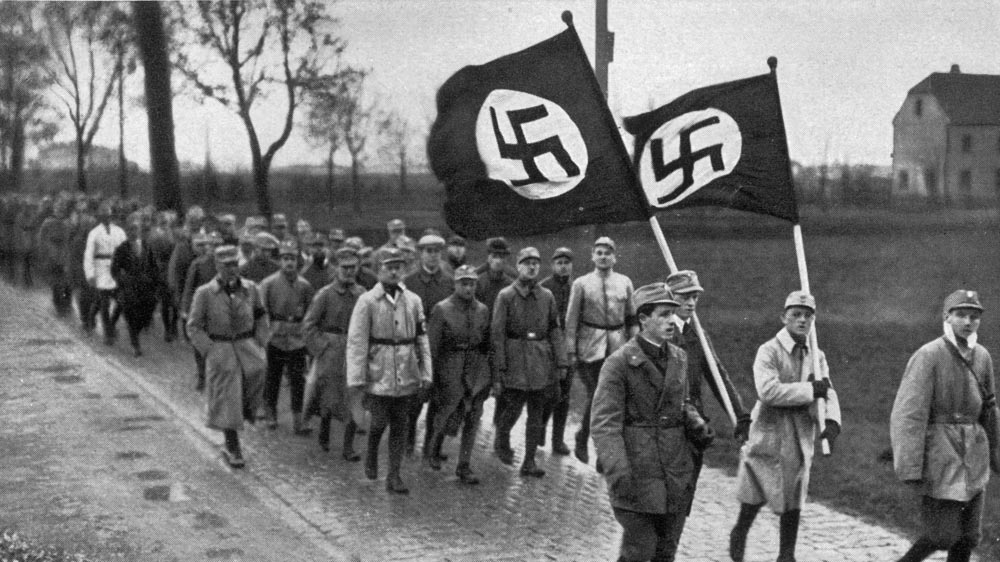  Members of the SA, the paramilitary wing of the Nazi party, during a training march outside Munich [Hulton Archive/Getty Images]