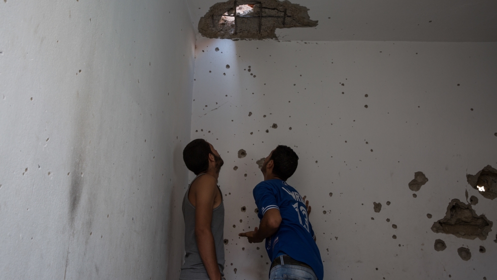  Young men from Kasserine examine damage to a house where the Tunisian army killed two suspected 'terrorists' after an hours-long shootout [Ioana Moldovan/Al Jazeera]