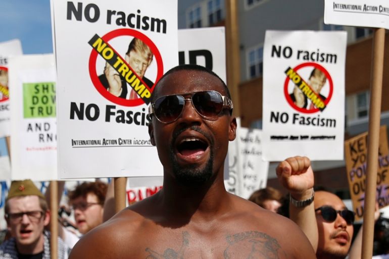 A demonstrator yells during a march by various groups, including "Black Lives Matter" and "Shut Down Trump and the RNC", ahead of the Republican National Convention in Cleveland