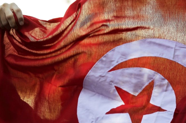 File photo of a person holding up a Tunisian flag and shouts slogans during celebrations marking the fourth anniversary of Tunisia''s 2011 revolution, in Habib Bourguiba Avenue in Tunis