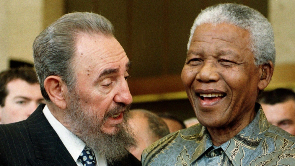 Castro speaking to Mandela at the 50th anniversary of the GATT Agreement [Patrick Aviolat/  EPA] 