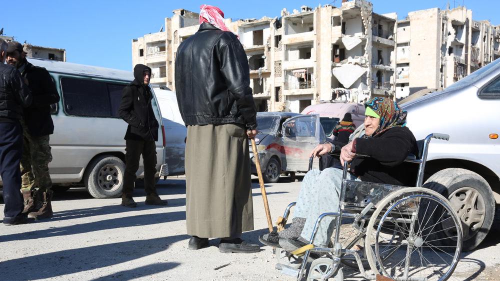An elderly women waits to be evacuated from Aleppo on Thursday [Malek al-Shimale/Al Jazeera]