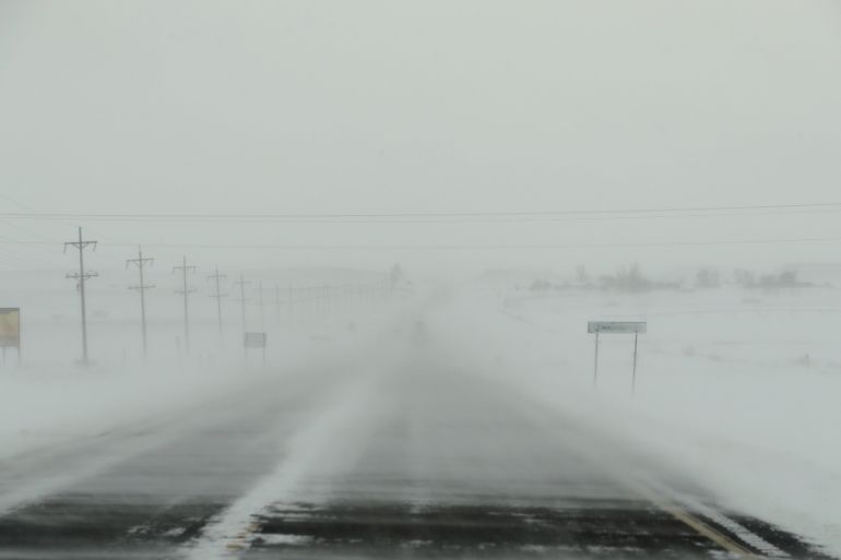 The wind blows snow across highway 1806 as a blizzard hits the Standing Rock Indian Reservation, near Fort Yates, North Dakota