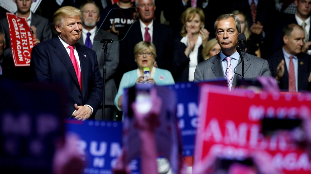 Republican presidential nominee Donald Trump, left, watches as MEP Nigel Farage speaks at a campaign rally in Jackson, Mississippi on August 24, 2016 [Carlo Allegri/Reuters]