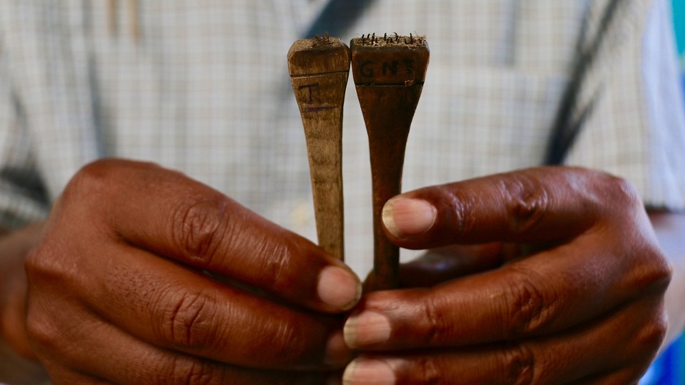 Velomora proudly shows off the tool his family used to use when marking their vanilla beans [Peter Lind/Danwatch]