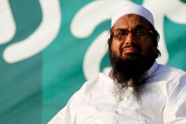 Hafiz Muhammad Saeed, chief of the banned Islamic charity Jamat-ud-Dawa, looks over the crowed as they end a "Kashmir Caravan" from Lahore with a protest in Islamabad