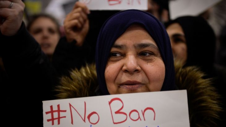 A Muslim women holds a sign during anti-Donald Trump travel ban protests outside Philadelphia International Airport in Philadelphia