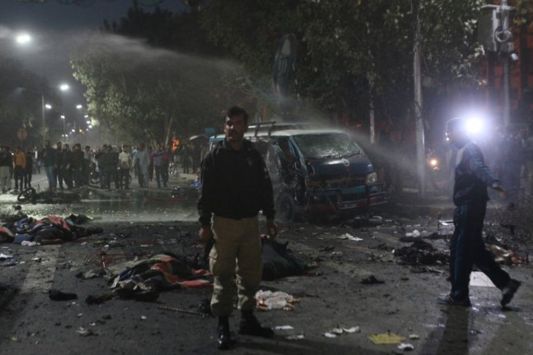 A policeman stands guard at the scene after a blast in Lahore