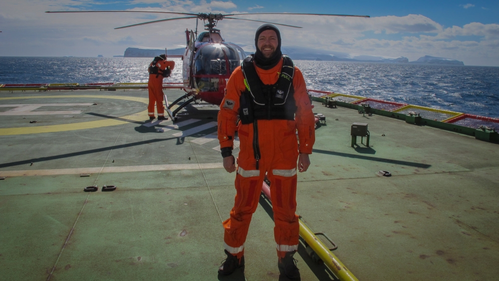 Science Editor Tarek Bazley takes part in the first ever photographic survey by helicopter of the Balleny Islands, off Antarctica [AJE/Tarek Bazley]