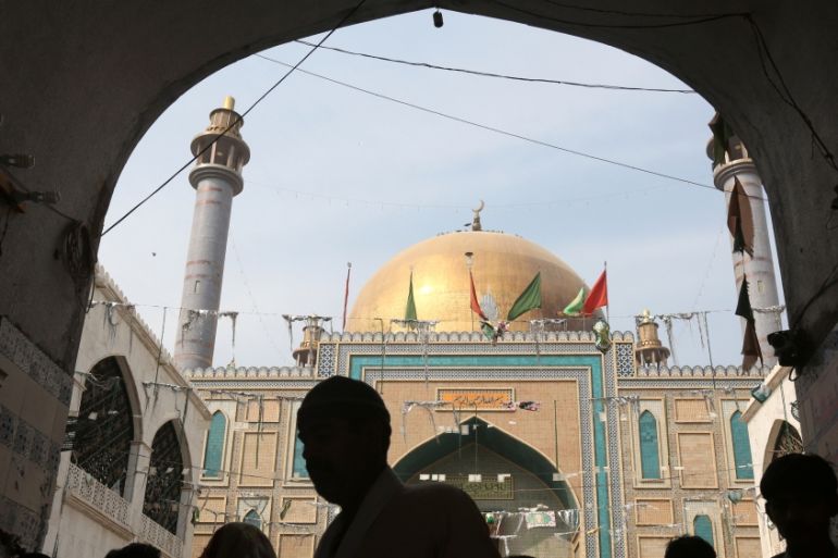 Devotees are silhouetted as they gather at the tomb of Sufi saint Syed Usman Marwandi, also known as the Lal Shahbaz Qalandar shrine, after Thursday''s suicide blast, in Sehwan Sharif