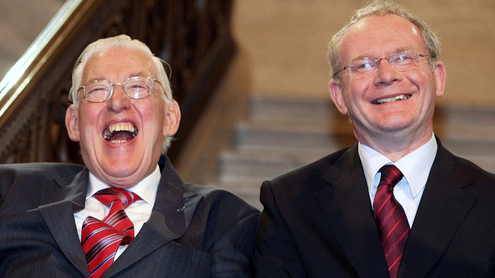 Northern Ireland's first minister Ian Paisley, left, and deputy first minister Martin McGuinness smiling after being sworn in at a ceremony at Stormont, Belfast in May 2007 [Paul Faith/Reuters]