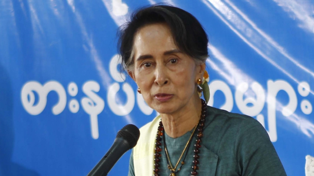 Aung San Suu Kyi talks to people at Mai Na internally displaced persons (IDPs) camp near Myitkyina, the capital of Kachin State, northern Myanmar, in March 2017 [Si Thu/EPA]
