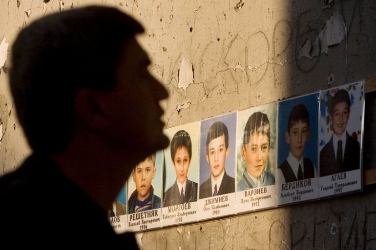 FILE PHOTO - A man mourns inside the Beslan school gymnasium