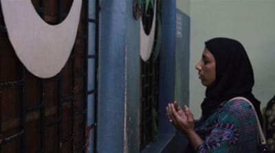 A woman prays at Cheraman mosque [Hui Zhong/Al Jazeera]