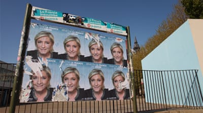 A defaced campaign poster for defeated presidential candidate Marine Le Pen outside Jean Jaures High School in Calais. The far-right nationalist won the vote here, but locals remain divided on her policies [Elaine Allaby/Al Jazeera]