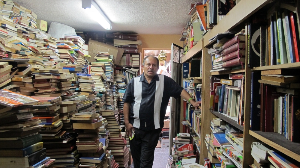 The last time Jose counted, there were some 25,000 books in the downstairs area of his family's house [Smriti Daniel/Al Jazeera]