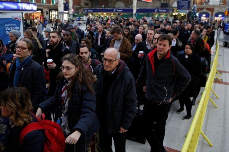 FILE PHOTO: Passengers queue for a reduced Gatwick Express service during the Southern railway strike at Victoria station in London