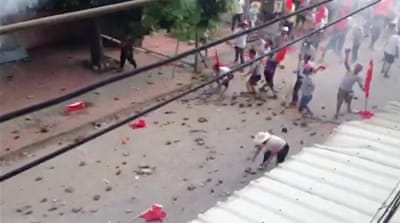 Protesters throw rocks at police on September 13, 2016, in Wukan [Screengrab/Al Jazeera]
