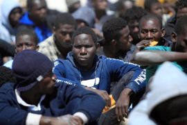 Migrants rest after they were rescued by the Libyan Coast Guard, at a naval post in the coastal town of Tajoura
