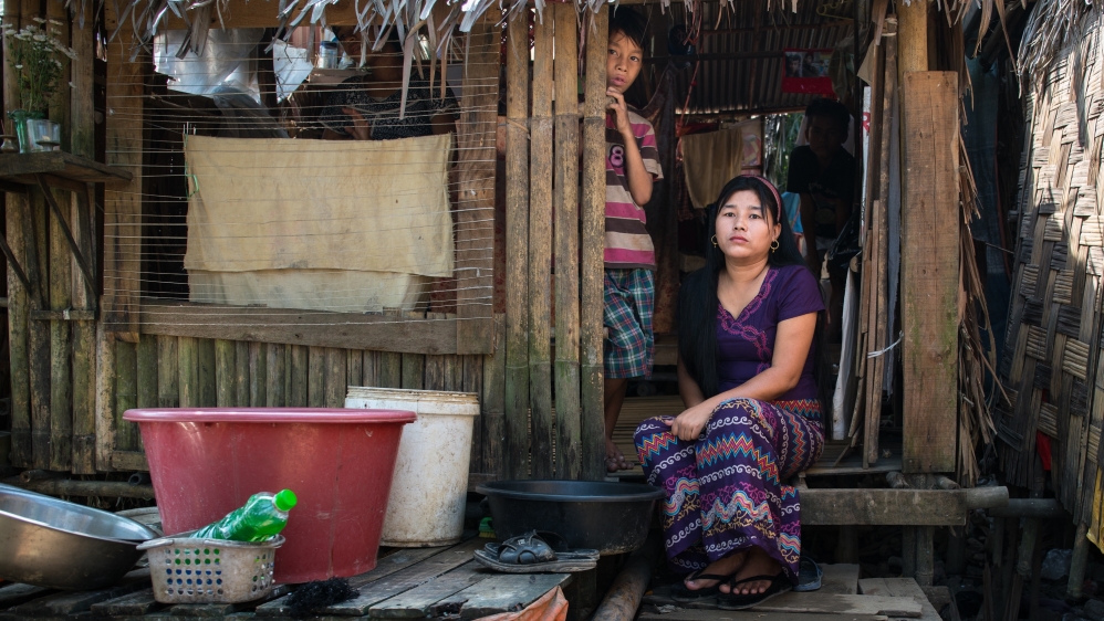 Ma Ei Pyi and her son at her house in Hlaing Thayar [Katie Arnold/Al Jazeera]