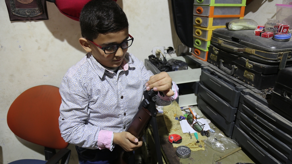 Nasser has spent the past two years repairing shotguns in his father's shop in al-Nusairat refugee camp [Sanaa Kamal/Al Jazeera]