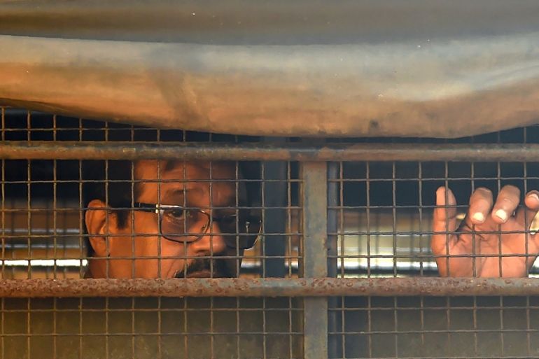 Indian convicted for his role in the 1993 Mumbai bomb blasts sits inside a police van
