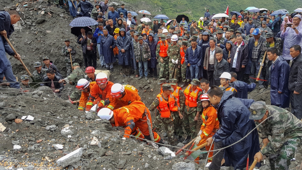 
People search for survivors at the site of a landslide in the Sichuan province of China on Saturday [Reuters]
 
