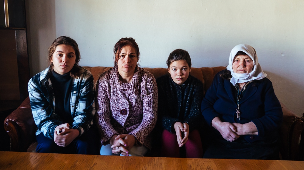 Three generations of women: Migena, Rezarta, Beta and Liza wait inside their family home in northern Albania for news of their father's asylum application in London, UK [Al Jazeera]