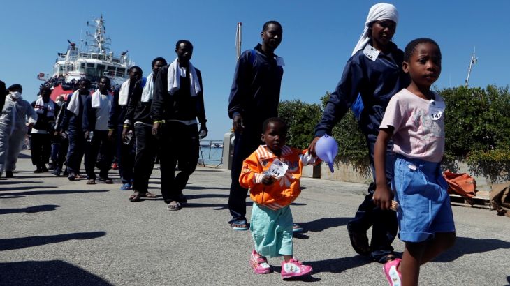 Migrants disembark from "Vos Prudence" Offshore Tug Supply ship as they arrive at the harbour in Naples