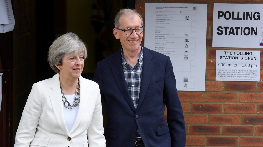 May arrives with her husband Philip to vote in Berkshire [Toby Melville/Reuters]