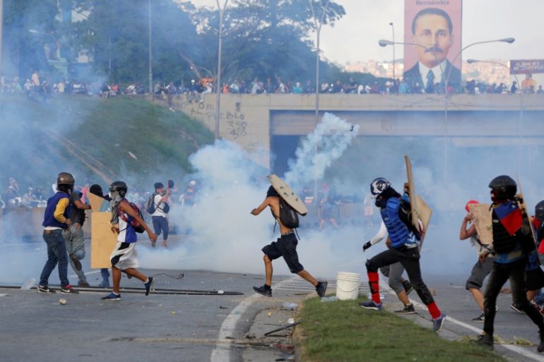 Demonstrators clash with riot security forces while rallying against Venezuela''s President Nicolas Maduro''s Government in Caracas