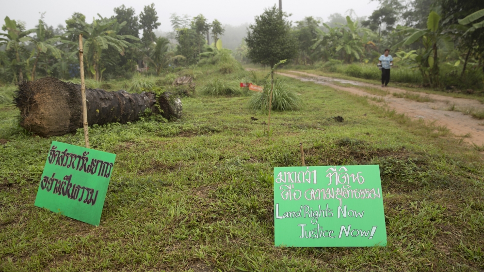 Signs asking for land rights dot the area during the memorial day of Klong Sai Pattana village in remembrance for each of the four people murdered during their prolonged fight to remain on the land [Luke Duggleby/Al Jazeera]