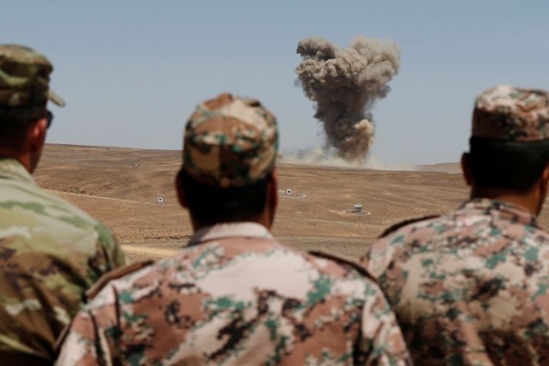 Jordanian soldiers watch as smoke rises during Eager Lion military exercises at the Jordan-Saudi Arabia border, south of Amman